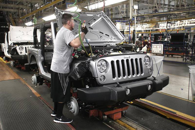 A worker assembles the 2014 Jeep Wrangler. Bill Pugliano / Getty Images / AFP