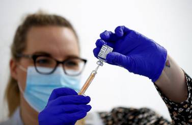 A health worker fills a syringe with a dose of the Oxford/AstraZeneca vaccine which is being rolled out across the UK. Reuters.