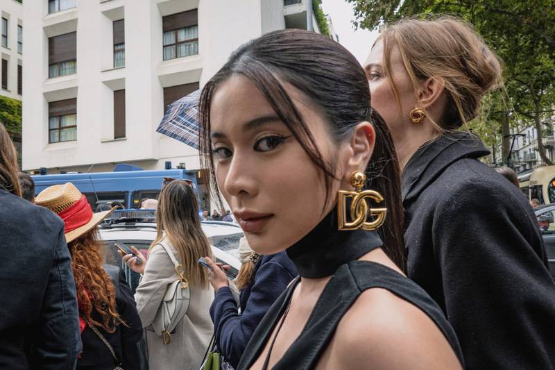 A guest, wearing Dolce & Gabbana logo earrings, ahead of the show. LaPresse via AP