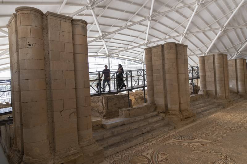 Visitors roam the site of the 7th century mosaic. AP