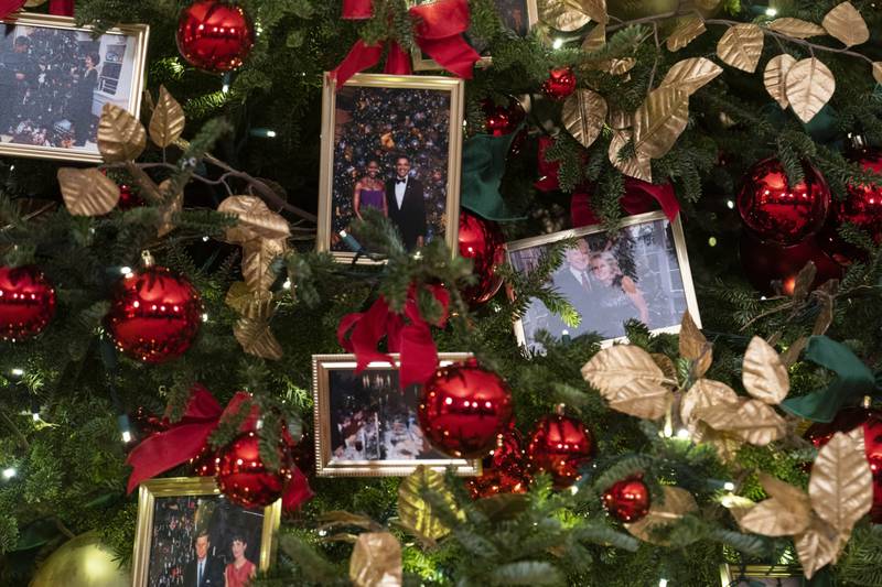 A Christmas tree is seen decorated with photos of US President Joe Biden, first lady Jill Biden in the State Dining Room of the White House in Washington. Bloomberg