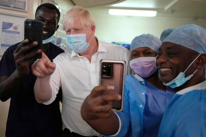 British Prime Minister Boris Johnson poses for a photograph with members of staff at the South-West London Elective Orthopaedic Centre in Epsom on Friday. AFP