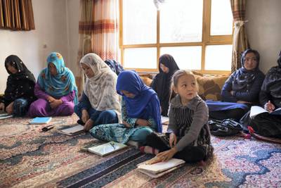 Tahira, right, front row, and Kobra, sitting beside her, attend class at Markaz-e-Amozish in Kabul. Both girls are from Behsud in Afghanistan's Maidan Wardak province but their families were forced to flee because of fighting between government forces and insurgents. Kern Hendricks for The National
