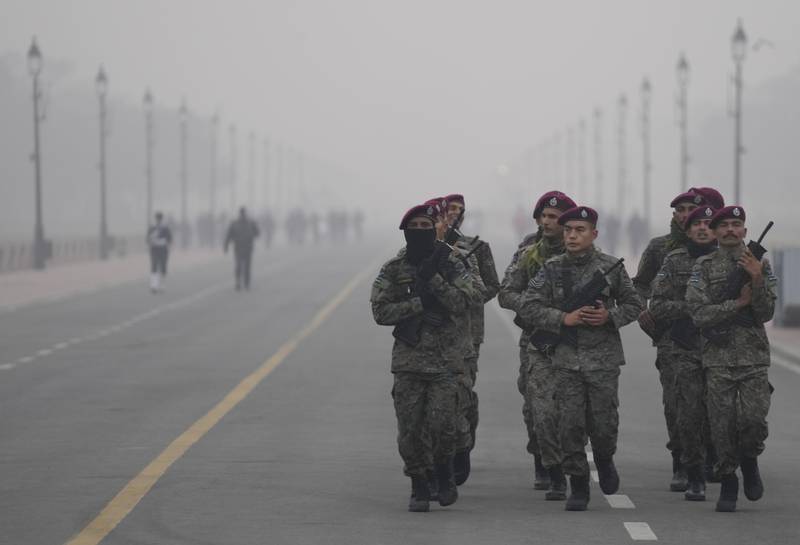 Indian army soldiers train in fog in New Delhi. AP Photo