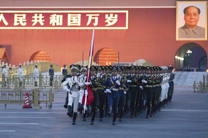 In Tiananmen Square in Beijing, an honour guard marches to a flag-raising ceremony on October 1 to mark the 73rd anniversary of the founding of the People's Republic of China. AP