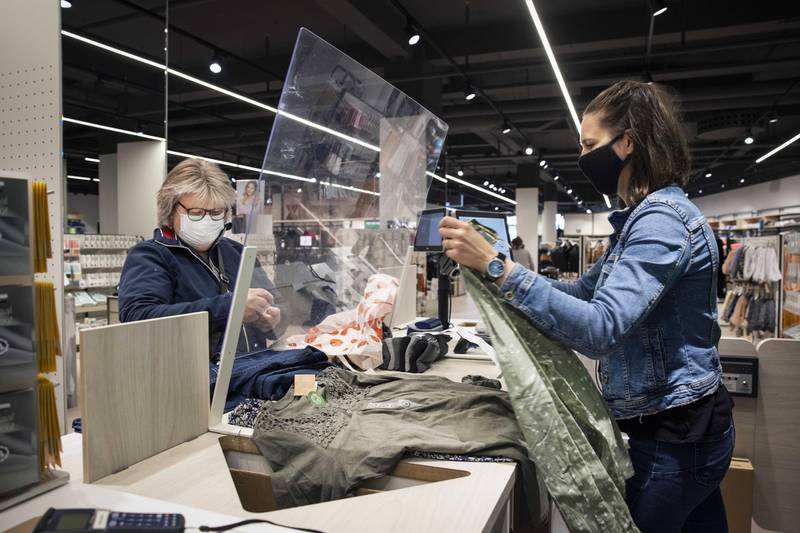Customers visit a clothing store in Hilversum, the Netherlands. Stores can now welcome customers again without an appointment, as a part of the relaxation of restrictions. EPA