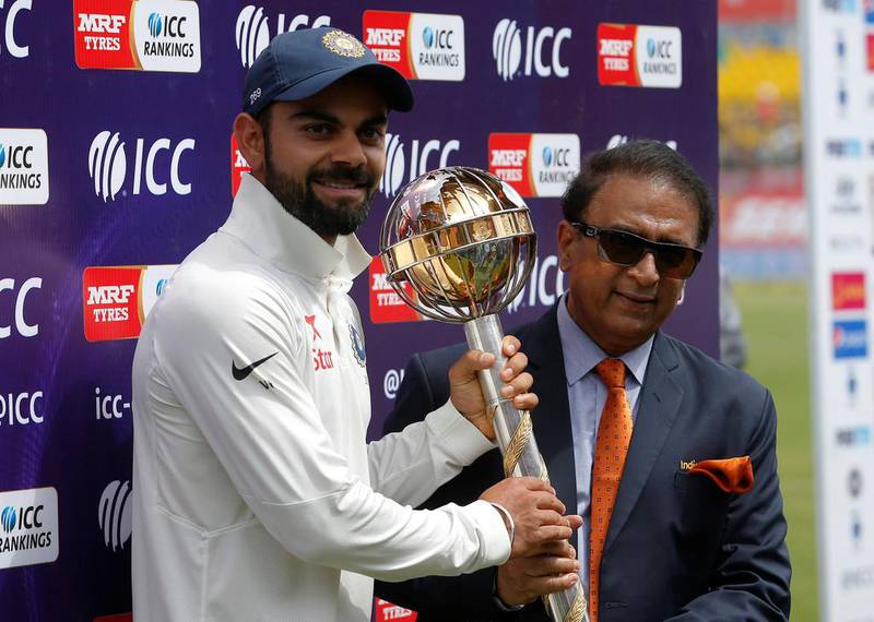 India captain Virat Kohli receives the ICC Test Mace from former cricket player Sunil Gavaskar at Dharamshala on Tuesday. Adnan Abidi / Reuters