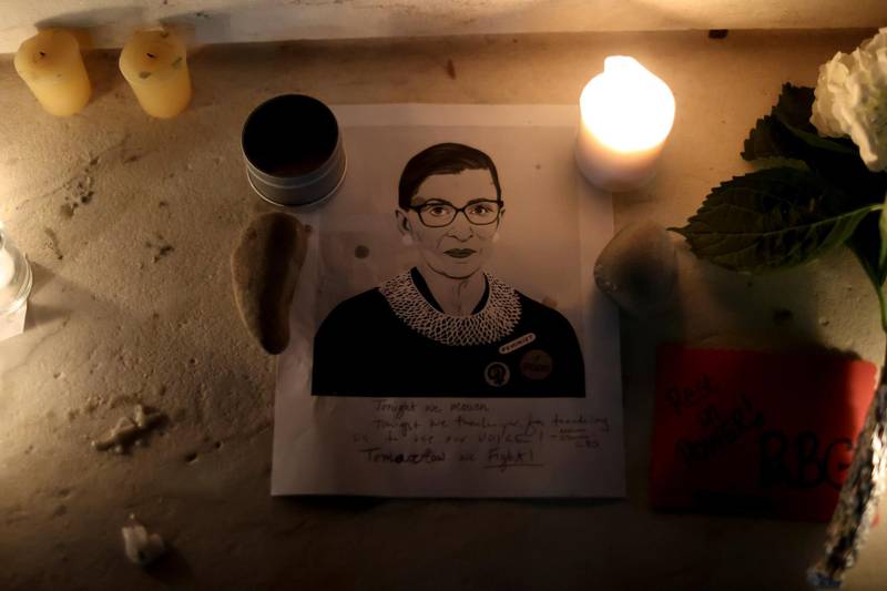 Candles and an image of late U.S. Supreme Court Justice Ruth Bader Ginsburg are seen as people gather in front of the U.S. Supreme Court following her death, in Washington, U.S., September 19, 2020. REUTERS/Jonathan Ernst