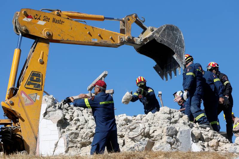 Firefighters look for people in the rubble of a demolished church following the earthquake on Crete. Photo: Reuters