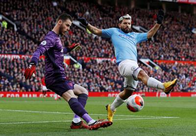 Manchester United's David de Gea clears the ball under pressure from Manchester City's Sergio Aguero. Reuters