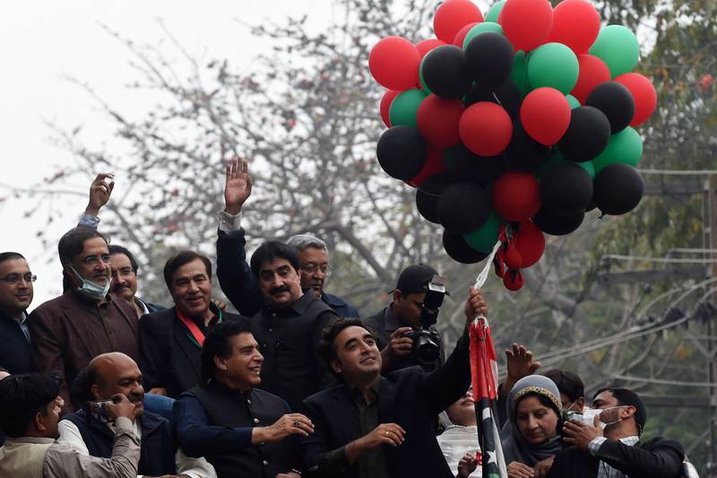The PPP leader releases balloons as the anti-government march reaches Lahore. AFP