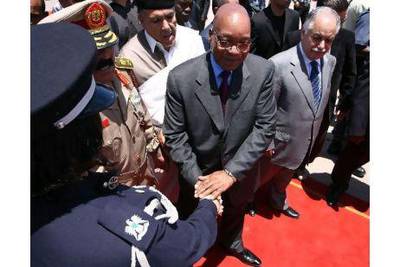 South African President Jacob Zuma (centre) shakes hands with an honour guard member as he is greeted by the Libyan prime minister, Baghdadi al Mahmudi, (right) upon his arrival in Tripoli yesterday for talks on ending a conflict with rebels fighting to oust Muammar Qaddafi. Mahmud Turkia / AFP Photo