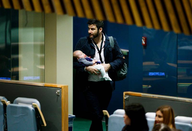 Clarke Gayford, partner of New Zealand Prime Minister Jacinda Ardern, carries their daughter Neve after listening to Ardern speak at the Nelson Mandela Peace Summit during the 73rd session of the General Assembly of the United Nations at United Nations Headquarters.  EPA