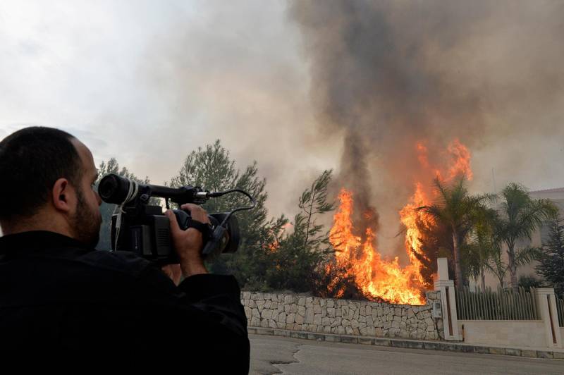 A cameraman films a fire near a house in Mechref area south Beirut, Lebanon.  EPA