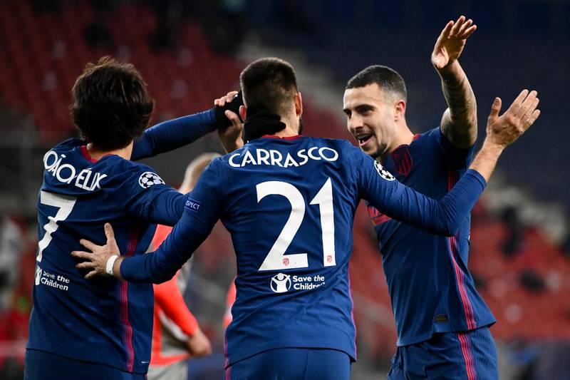 Atletico's Yannick Carrasco celebrates with Joao Felix, left, and Mario Hermoso after scoring their second goal against Salzburg. AP