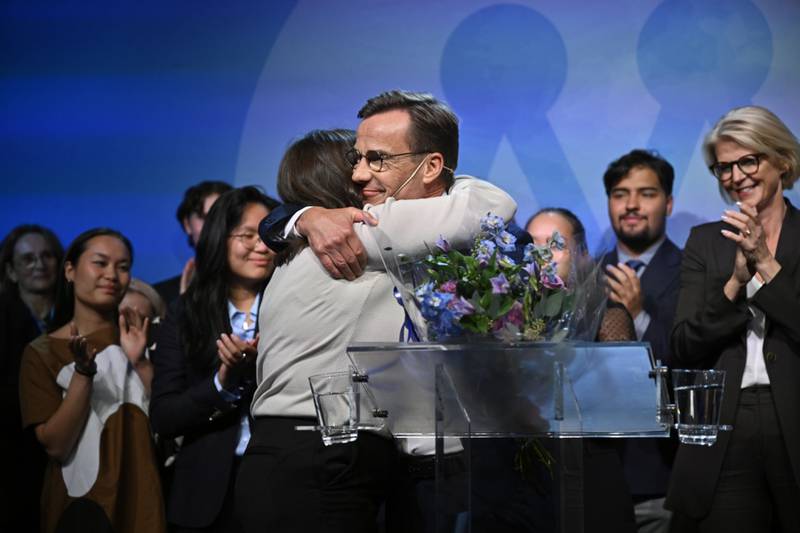 Ulf Kristersson, leader of the Moderate Party, centre, receives a hug during the party's election night event in Stockholm. Bloomberg