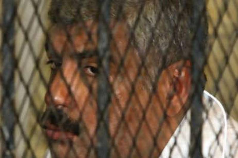 The Egyptian tycoon Hisham Talaat Moustafa, charged with paying for the murder of Lebanese singer Suzanne Tamim, sits inside the defendants' cage during his trial at a court in Cairo on Oct 18 2008.