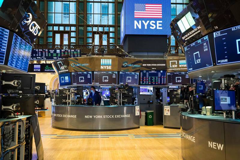 In this photo provided by the New York Stock Exchange, employees work on the partially reopened trading floor, Tuesday, May 26, 2020. Stocks surged on Wall Street in afternoon trading Tuesday, driving the S&P 500 to its highest level in nearly three months, as hopes for economic recovery overshadow worries about the coronavirus pandemic. (Courtney Crow/New York Stock Exchange via AP)