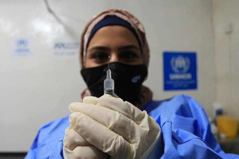 A medical worker prepares the coronavirus vaccine made by Sinopharm to administer to Syrian refugees in Jordan. AP Photo