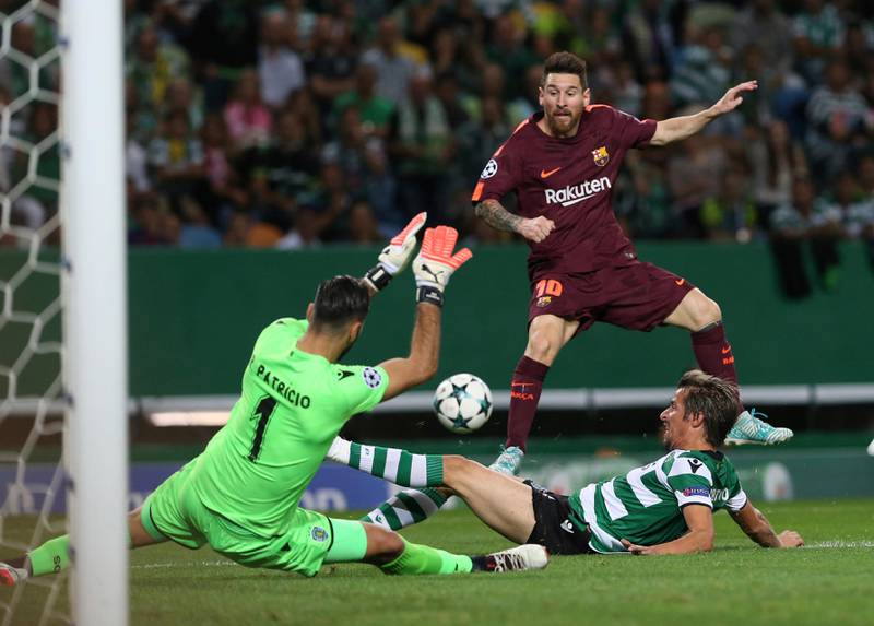 Barcelona's Lionel Messi takes a shot at goal as Sporting's Fabio Coentrao and Sporting goalkeeper Rui Patricio try to stop him. Armando Franca / AP Photo