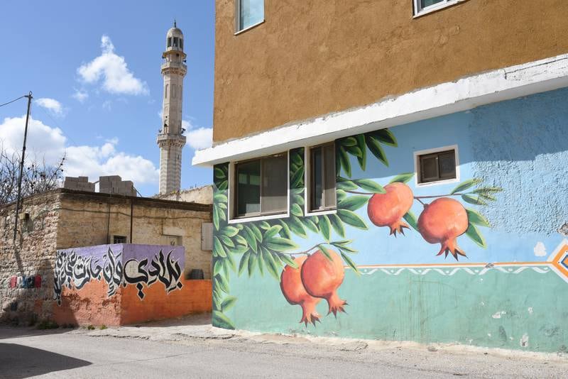 A mosque and murals in Beitin, West Bank. 