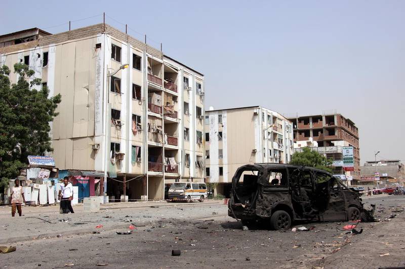 Aden residents inspect the site of a car bomb attack that targeted a police station.  EPA