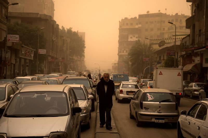 A man walks during a sandstorm in Cairo. EPA
