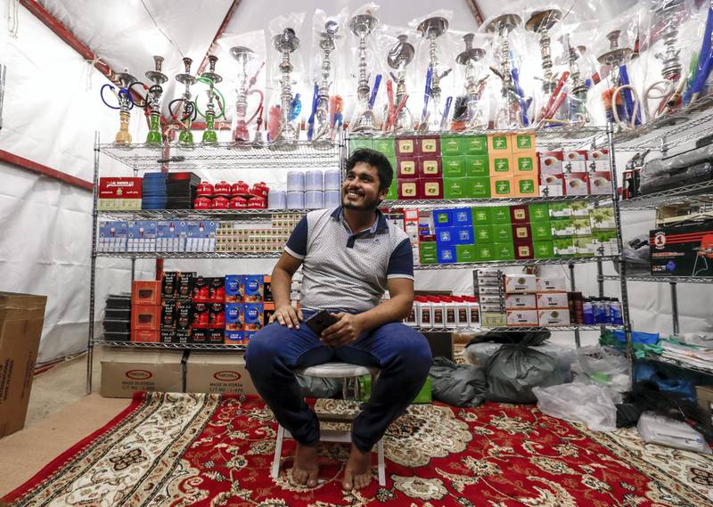 Abu Dhabi, United Arab Emirates, December 10, 2019.    -- Mohammed Shaddad, from Bangladesh, runs one of two tobacco shops on Millions Street  at the Al Dhafra Festival.Victor Besa/The NationalSection:  NAReporter:  Anna Zacharias