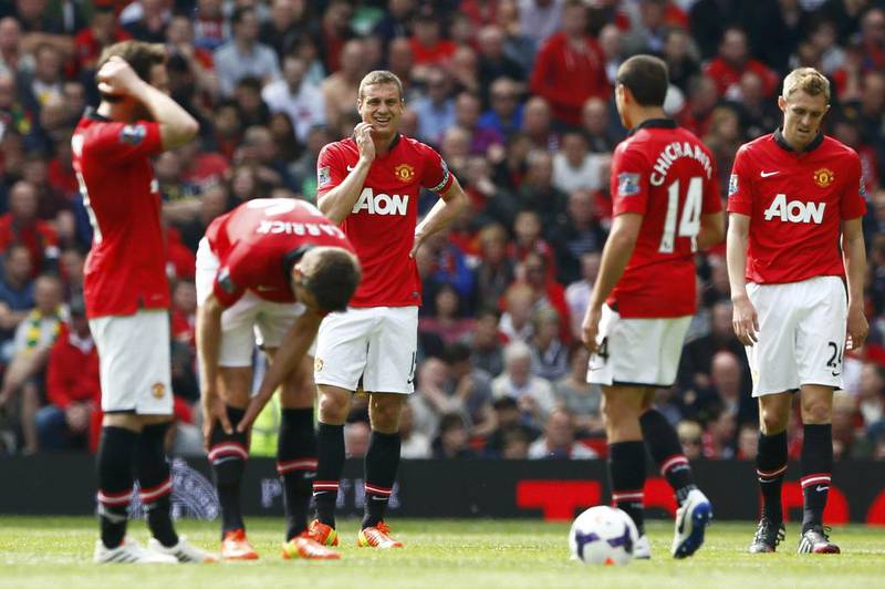 Manchester United captain Nemanja Vidic, centre, and his teammates react after conceding a goal to Sunderland during their Premier League match at Old Trafford in Manchester on May 3, 2014. Darren Staples / Reuters