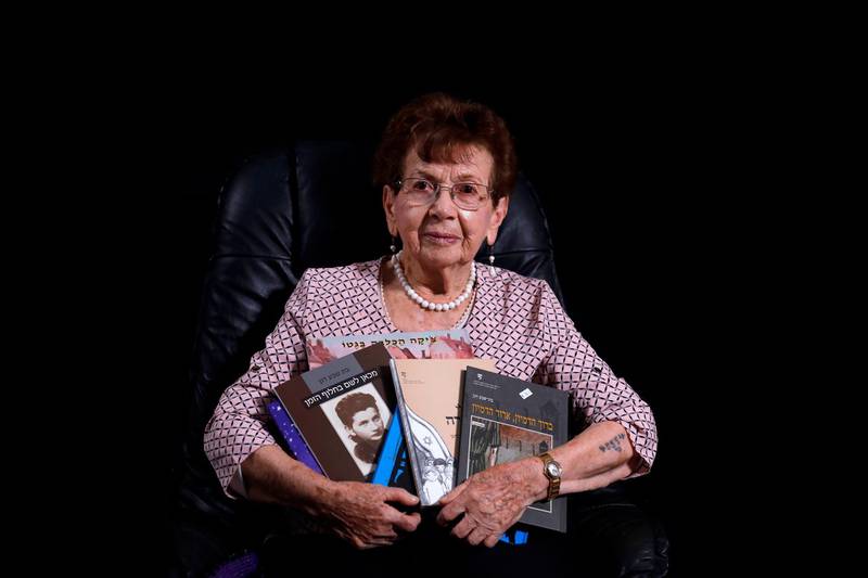 Holocaust survivor Batcheva Dagan, whose entire family was killed, poses with books she authored, during a photo session at her home in the Israeli town of Holon, south of Tel Aviv. Born in Poland in 1925, she became a pioneer in the field of Holocaust education, and has dedicated her life to teaching. Menahem Kahana / AFP