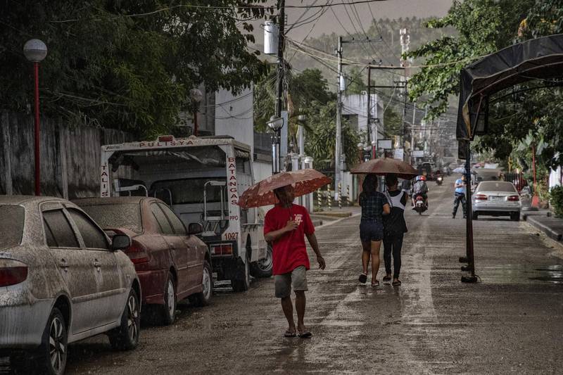 Residents walk along a road covered in ash mixed with rainwater as Taal Volcano erupts on January 12, 2020 in Talisay, Batangas province, Philippines. Getty Images
