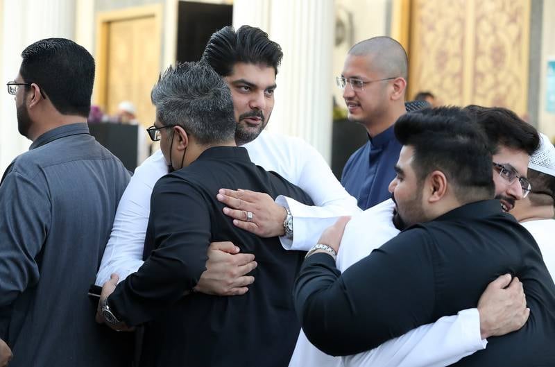 Worshippers embrace after morning prayers in Dubai. Pawan Singh / The National