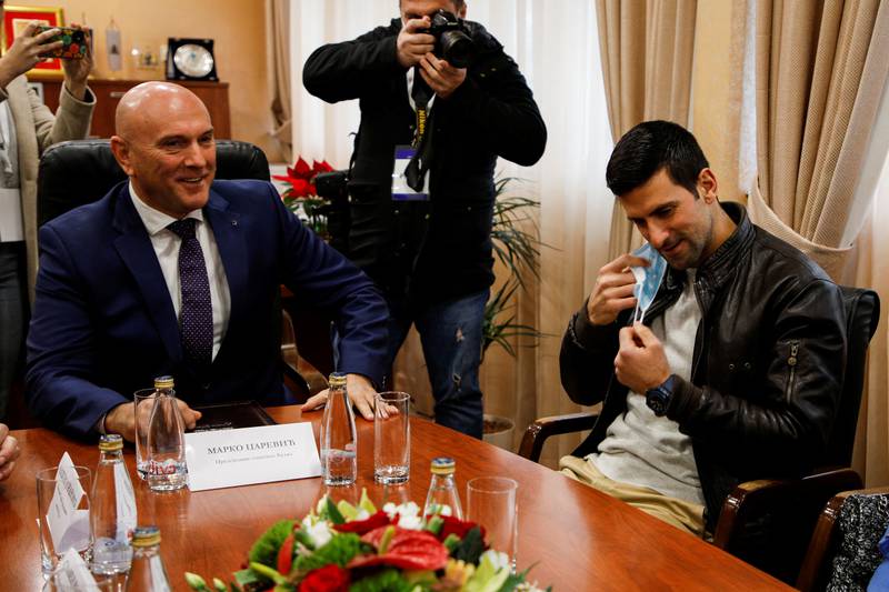 Serbian tennis player Novak Djokovic takes off his face mask during a meeting with Budva's Mayor Marko Bato Carevici, ten days after being deported from Australia after the country's Federal Court upheld a government decision to cancel his visa to play in the Australian Open, in Budva, Montenegro, January 28, 2022.  REUTERS / Stevo Vasiljevic