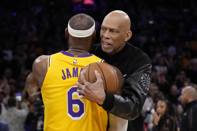 Los Angeles Lakers forward LeBron James, left, is hugged by Kareem Abdul-Jabbar in Los Angeles. AP