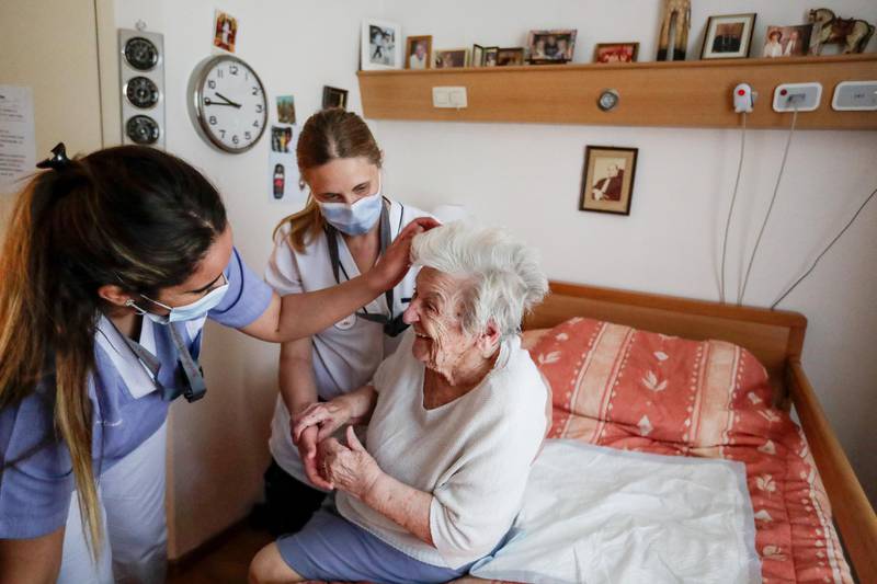 Mariette, a resident of the Christalain residence gets prepared by caregivers before the arrival of her daughter Patricia for a visit at Residence Christalain in Brussels, Belgium.  EPA