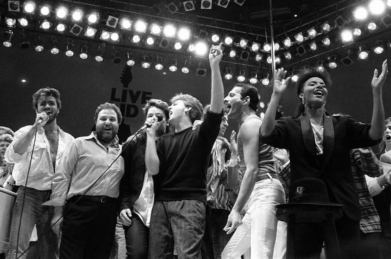 From left, George Michael, concert promoter Harvey Goldsmith, Bono of U2, Paul McCartney and Freddie Mercury of Queen join in the finale of the Live Aid famine relief concert at Wembley Stadium, London, on July 13, 1985. AP