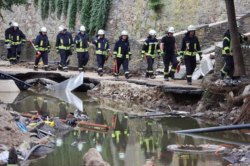 Firefighters make their way through an area hit by floods in Bad Muenstereifel, Germany.