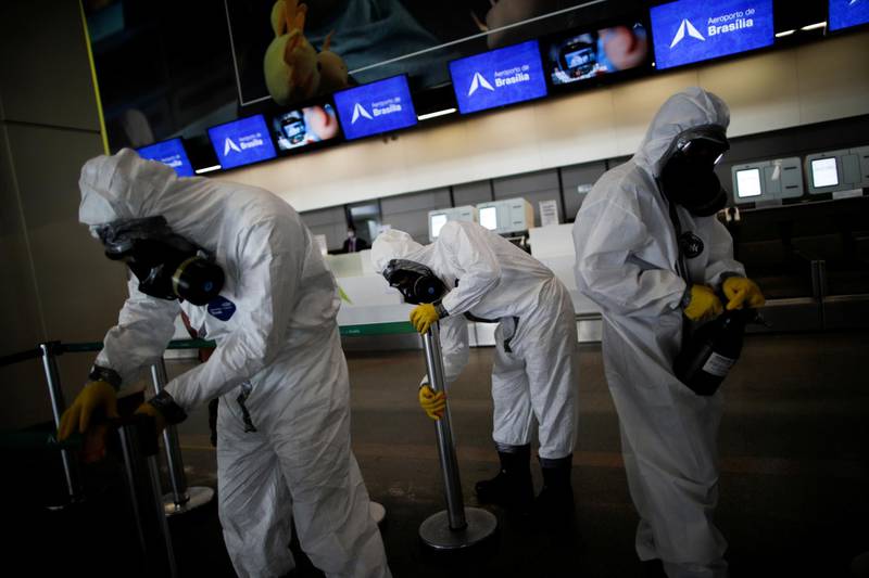 Members of the armed forces disinfect at Brasilia International Airport, amid the coronavirus disease (COVID-19) outbreak, in Brasilia, Brazil. REUTERS