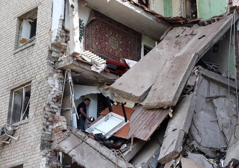 A man looks for his belongings in his destroyed apartment after a recent Russian air strike on Bakhmut in Ukraine. AFP