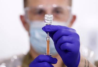 A military medic prepares the Oxford-AstraZeneca coronavirus vaccine before administering it to patients at the Elland Road mass vaccination centre in Leeds, England. AP