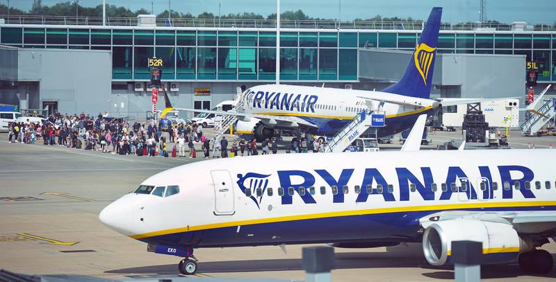 Passengers queue to board Ryanair aircraft at Stansted Airport, in south-east England. The airline is adding 500 flights from Stansted. PA