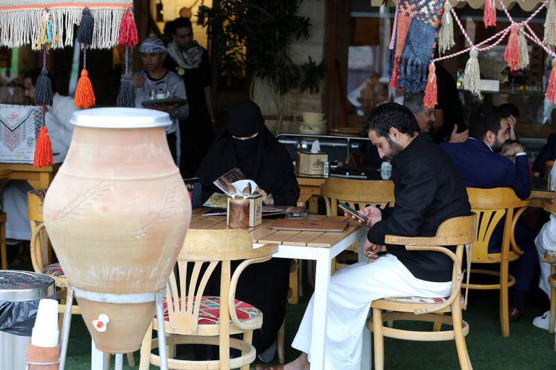 Men and women sit at a cafe in Riyadh. Reuters