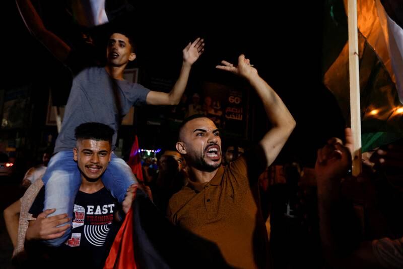 Palestinians celebrate on a street in Gaza city after a ceasefire was announced. Reuters