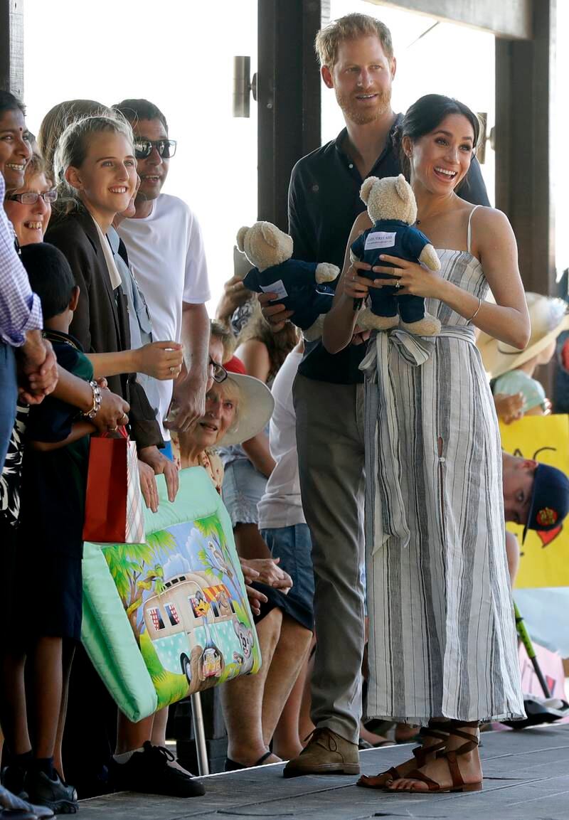 The couple receive gifts from the crowd. AP Photo