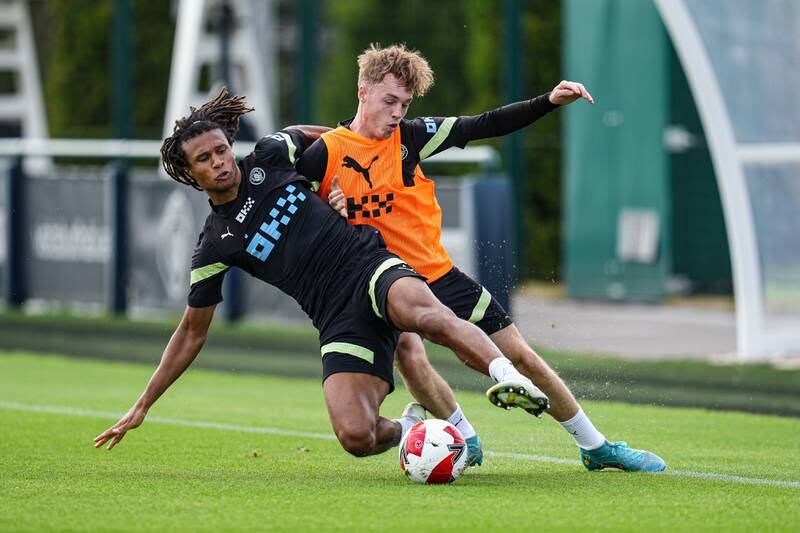 City's Nathan Ake and Cole Palmer battle for the ball during training. 