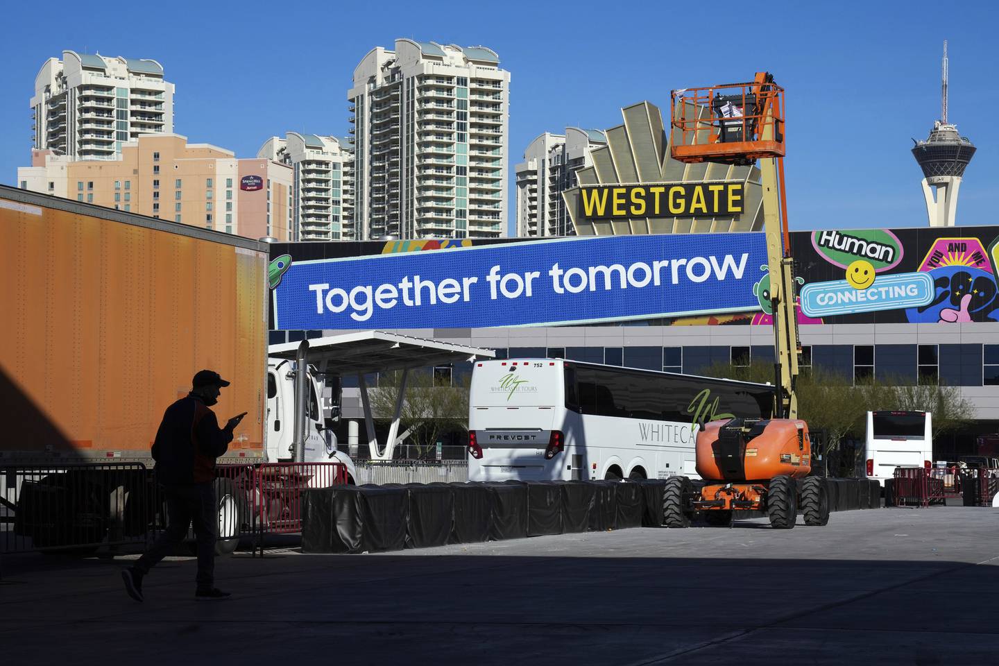 Workers prepare a booth before the CES technology show on Tuesday in Las Vegas. AP