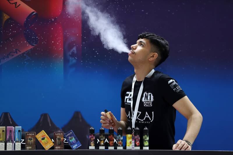 A sales representative trying a new vape at the World Vape Show held last week at Dubai World Trade Centre in Dubai. The exhibition is a platform where manufacturers can show their products. All photos: Pawan Singh / The National