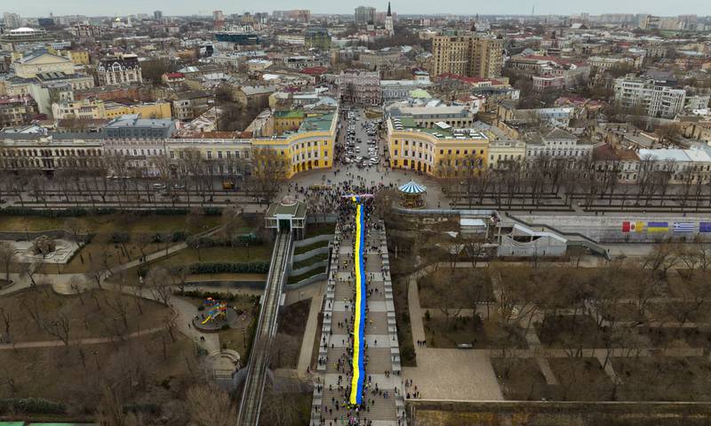 Demonstrators holding a huge Ukrainian flag march in Odessa. The protesters said they are prepared to defend their city in the event of a Russian invasion. AP