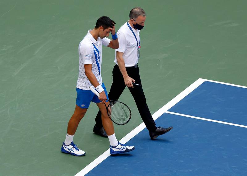 Novak Djokovic walks off the court with Soeren Friemel. EPA
