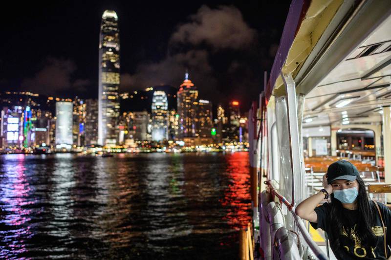 A woman wearing a face mask takes a Star Ferry in Victoria Harbour from Kowloon to Hong Kong Island. AFP
